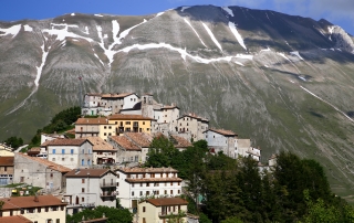 castelluccio di norcia with mountains behind